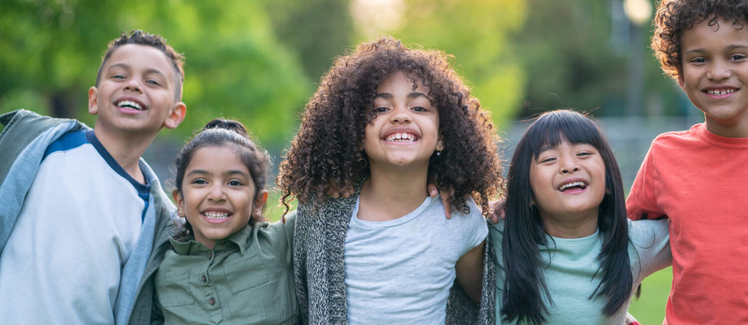 A group of smiling kids in the park
